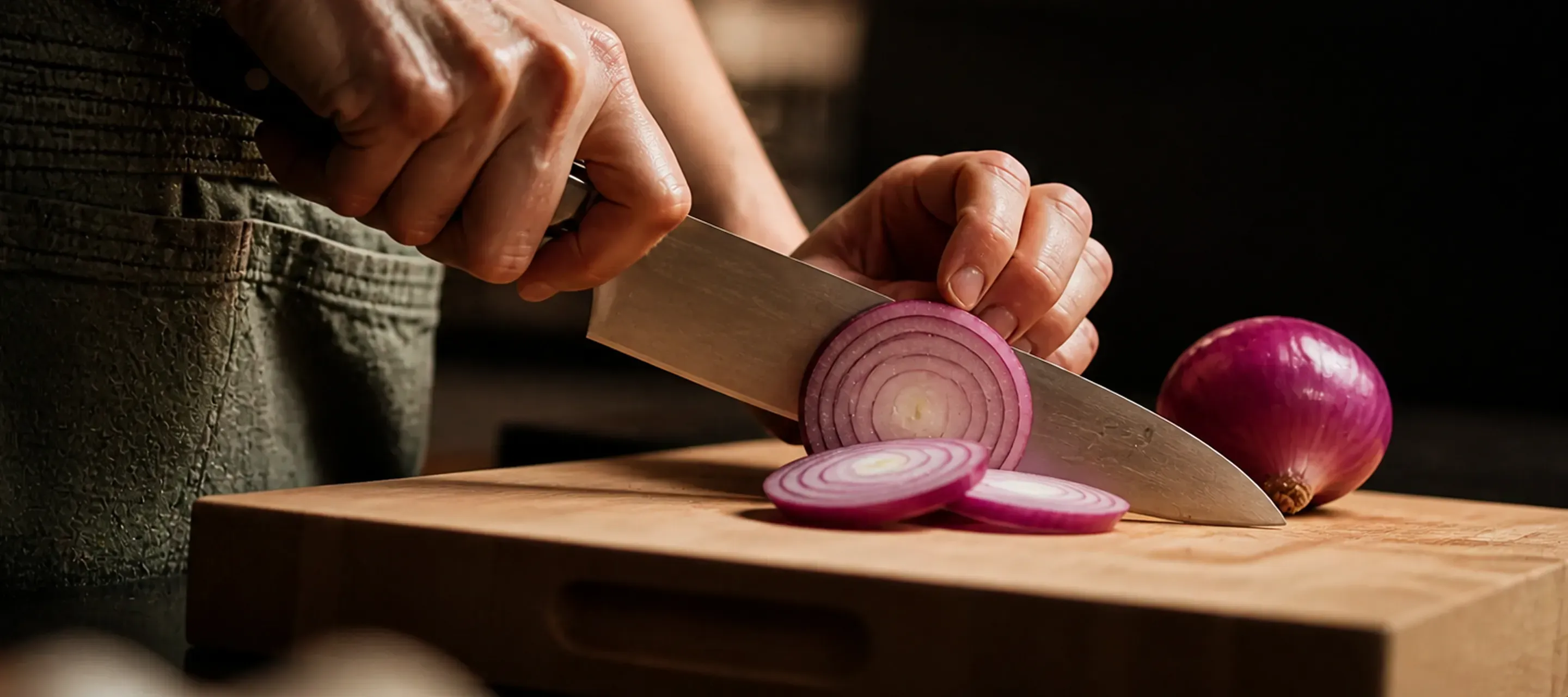 Kitchen knife cutting tomatoes on a board